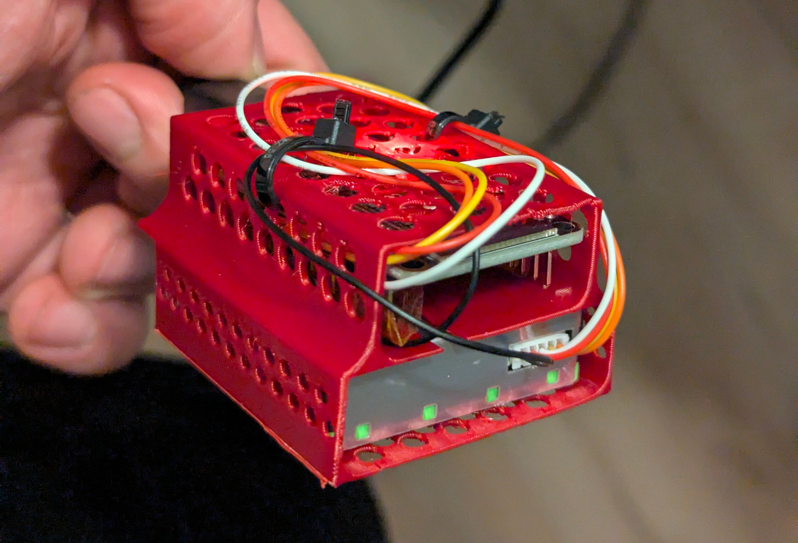 /assets/particlesensorinabrightred3dprintedhousingImadeinsolidworkswithholesformassreductionandreducedwaste.jpg
